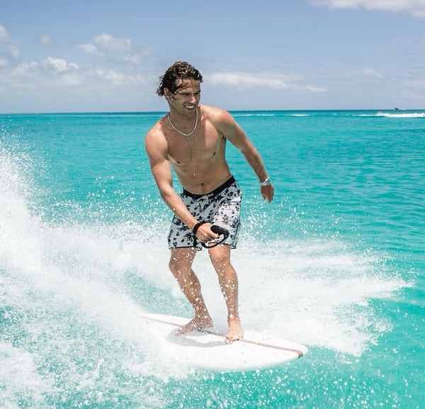 LIND electric surfboard ride on turquoise Caribbean water